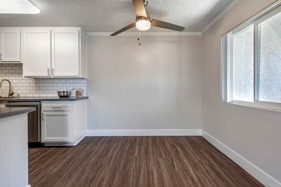 an empty kitchen and living room with a ceiling fan at Sage Creek Apartment Homes, Simi Valley, CA