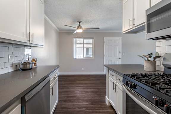 a kitchen with white cabinets and gray countertops at Sage Creek Apartment Homes, Simi Valley, CA 93063