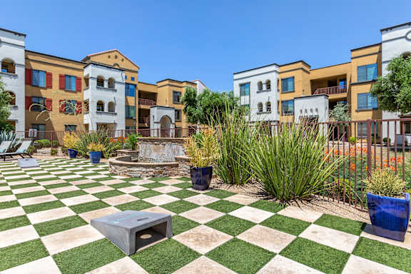 a green and white checkered picnic area in front of an apartment building at Trevi Apartment Homes, Arizona, 85224