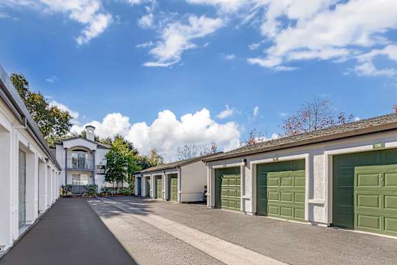 A row of green garage doors are on the right.