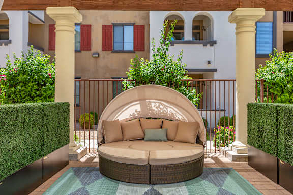 a curved seating area with a couch on a patio at Trevi Apartment Homes, Arizona, 85224