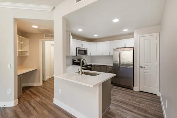 a kitchen with stainless steel appliances and a white counter top at Trevi Apartment Homes, Arizona, 85224