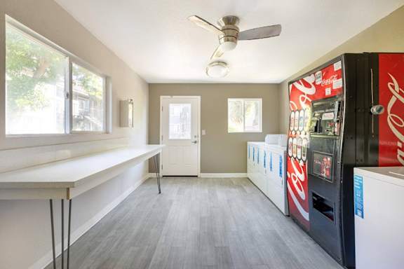 A room with a Coca Cola vending machine.