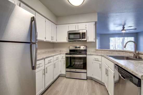 White Kitchen Cabinetry with Stainless Steel Appliances at Boulders at Lookout Mountain Apartment Homes, Phoenix, AZ