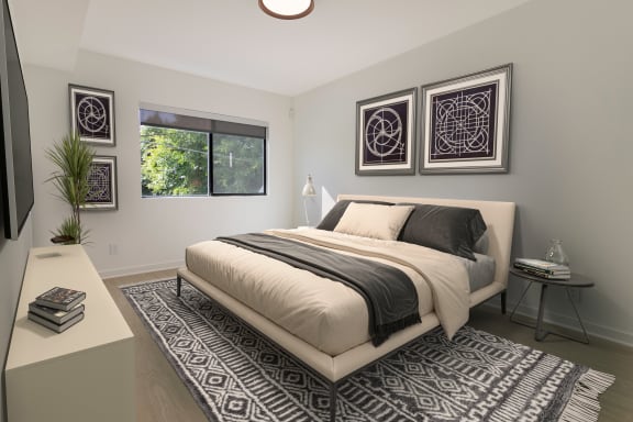 a bedroom with a bed and three paintings on the wall