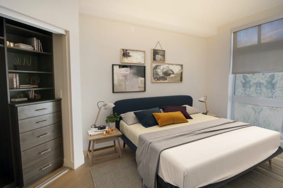 a bedroom with a bed and a bookcase in a 555 waverly unit