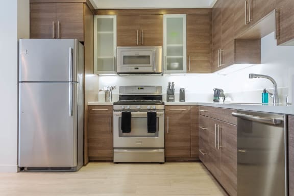 Floor Plan  a kitchen with wooden cabinets and stainless steel appliances