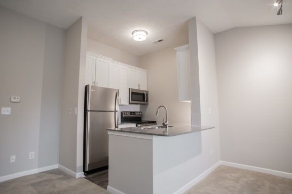 Fitted Kitchen With Island Dining at Sand Creek Woods Apartments, Indiana, 46037