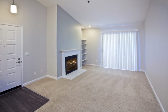 a living room with a fireplace and a window at Club Pacifica, Benicia, CA