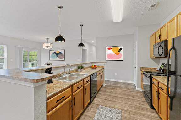 a spacious kitchen with wood cabinetry