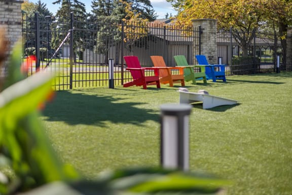 a group of colorful chairs sitting on the grass
