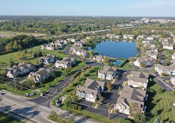 an aerial view of a neighborhood of houses around a lake