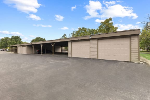 a large parking lot with a garage with doors