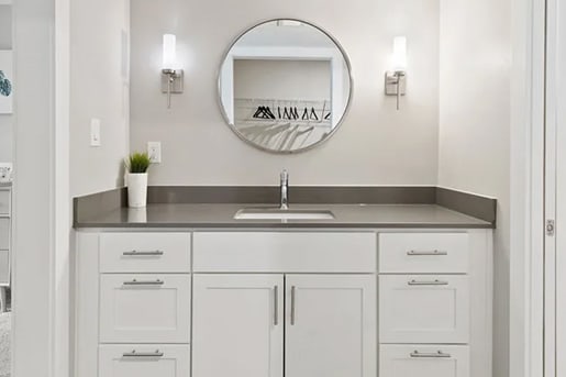 a white bathroom with a sink and a mirror