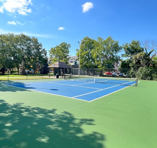 a blue and green tennis court with a black scoreboard