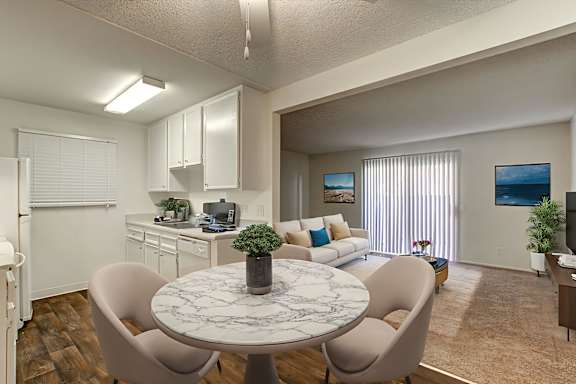 A dining room with a round marble table and chairs at Woodlake Apartments, Escondido, 92027
