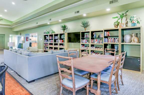 Community clubhouse with pool table and books at Country Club at The Meadows!