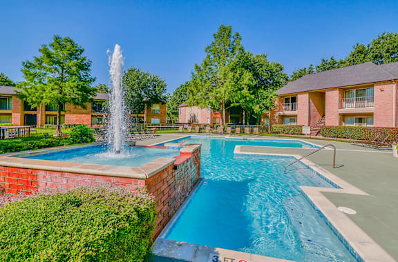 A pool with a waterfall in the middle of it.