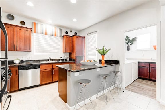 A kitchen with a black stove top oven and a white counter top.