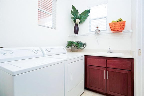 A white washing machine and dryer in a laundry room.