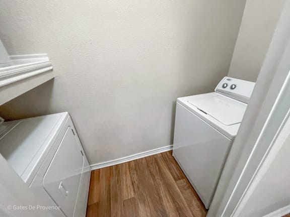 A small laundry room with a washer and dryer.