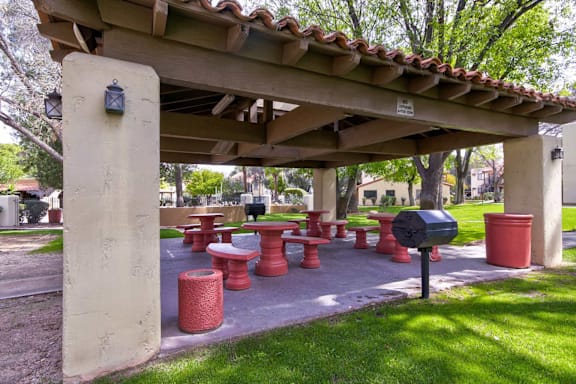 A covered picnic area with tables and benches.