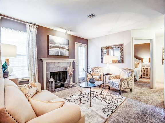 A living room with a fireplace and a couch at Riverside Park Apartments, Oklahoma