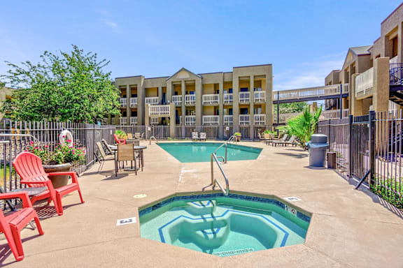 An outdoor swimming pool with a jacuzzi spa.