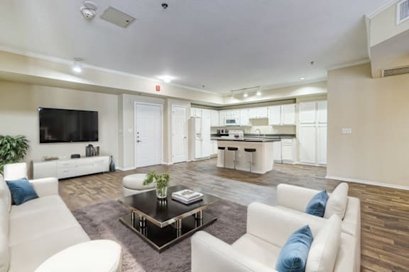 A modern living room with a white sofa and a coffee table.