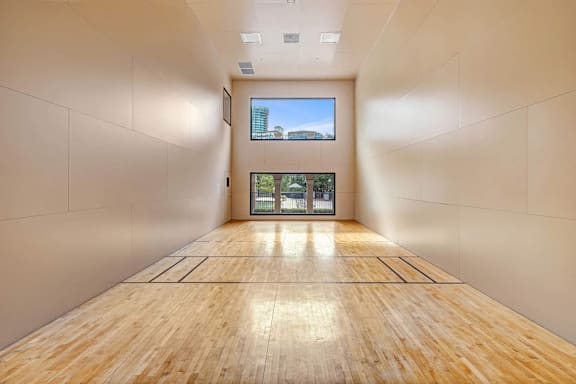 A long hallway with wooden floors and white walls.