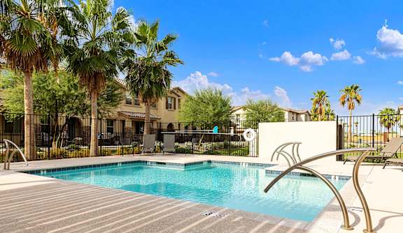 Rectangle Pool with modern style stainless steel  rails. Palm trees provide shade at Casa Sole Vita Townhomes, Mesa, AZ