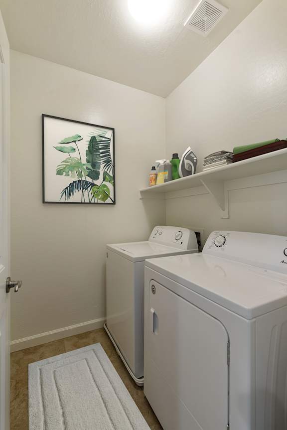 A small laundry room with a washer and dryer.