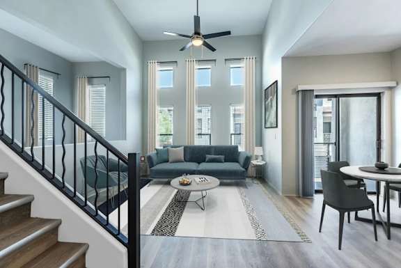 A modern living room with a staircase leading to the upper floor.