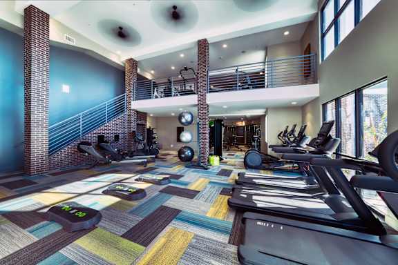 A gym with treadmills and exercise equipment.