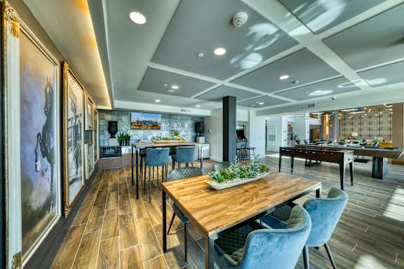 A dining room with a wooden table and blue chairs.