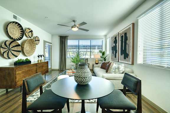 A modern dining room with a round table and chairs.
