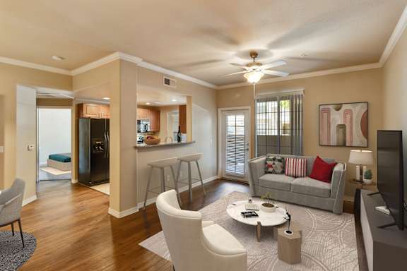 A living room with a grey couch, a coffee table, and a television. at Superstition Canyon Apartments, Arizona, 85209