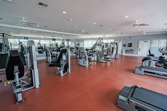 a gym with cardio machines and other exercise equipment