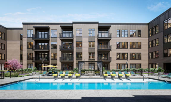a swimming pool is in front of an apartment building at Link Apartments® Broad Ave, Memphis, TN