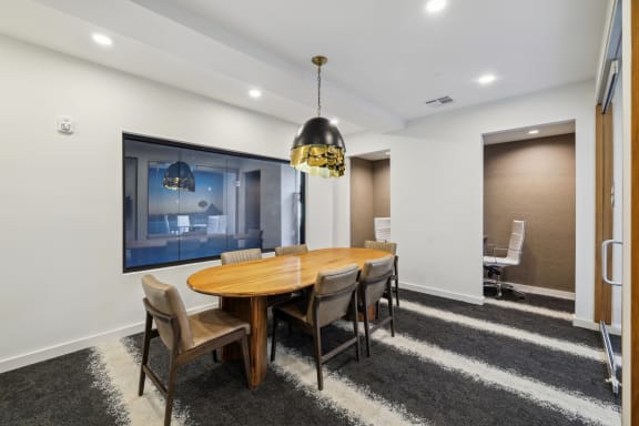 a dining room with a wooden table and chairs at Link Apartments® Broad Ave, Memphis, 38112
