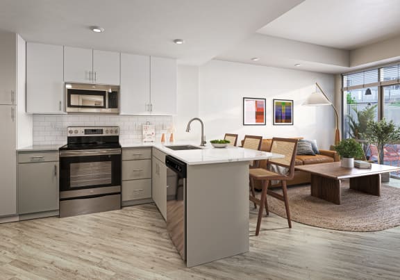 a kitchen and living room with an island and a dining room table at Link Apartments® Four 12, Oakland, CA