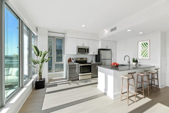 a kitchen with a large island and a large window  at Link Apartments&#xAE; H Street, Washington, DC