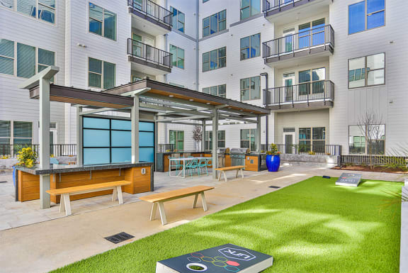 Large grill area with corn hole  at Link Apartments® Montford, Charlotte, 28209