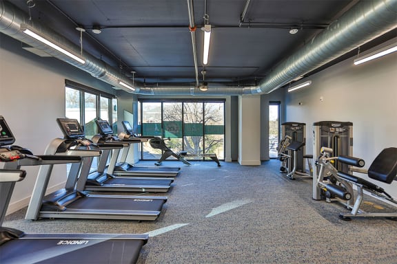 Large fitness center with cardio equipment at Link Apartments® Montford, North Carolina
