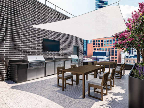 A patio with a table and chairs and a TV on the wall.