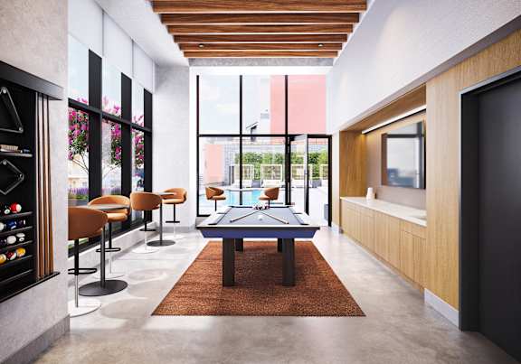 A modern living room with a pool table and a bar area.