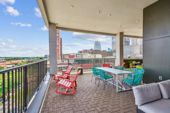a balcony with a table and chairs and a view of the city at Link Apartments Innovation Quarter, North Carolina