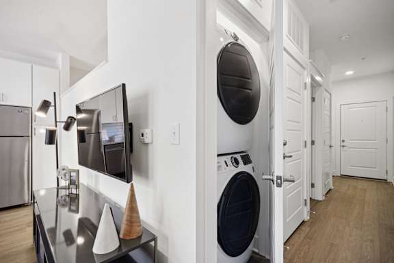 A modern kitchen with a washing machine built into the cabinetry.