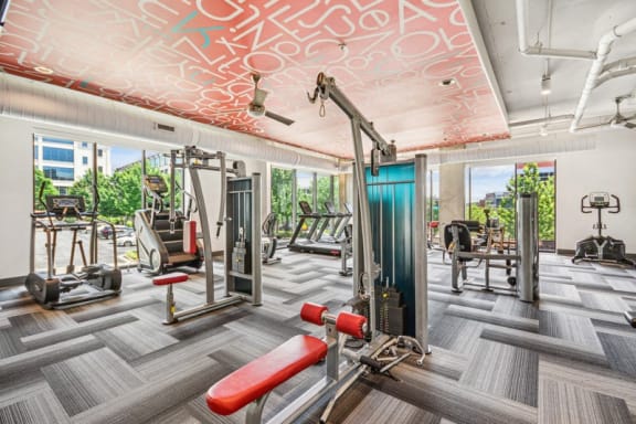the gym is equipped with cardio machines and other gym equipment at Link Apartments Innovation Quarter, Winston Salem, NC