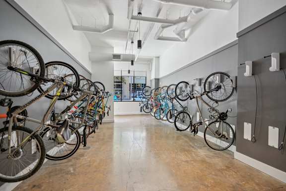 A bike rack with many bicycles parked. at Link Apartments® 4th Street, Winston-Salem, North Carolina